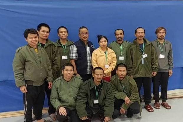 In this photo provided by Thailand's Foreign Ministry, ten of freed Thai hostages and an officer, fourth from left, pose for a photo at the Shamir Medical Center in Israel.(Thailand's Foreign Ministry via AP )