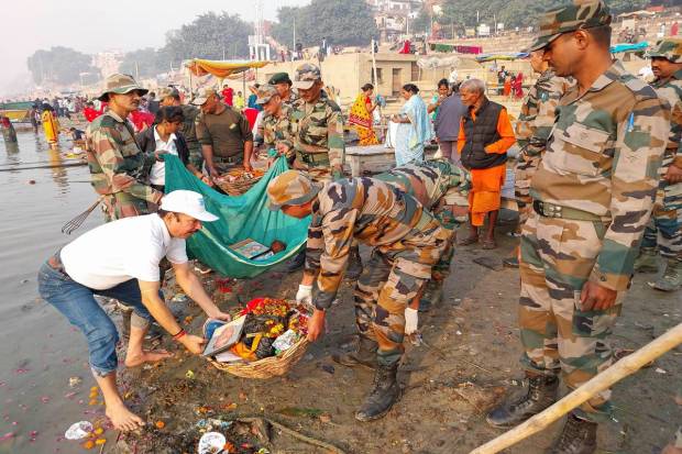Indian Army personnel participate in a cleanliness drive at the bank of Ganga river before celebration of 'Chhath Puja' festival, in Varanasi. (PTI Photo)