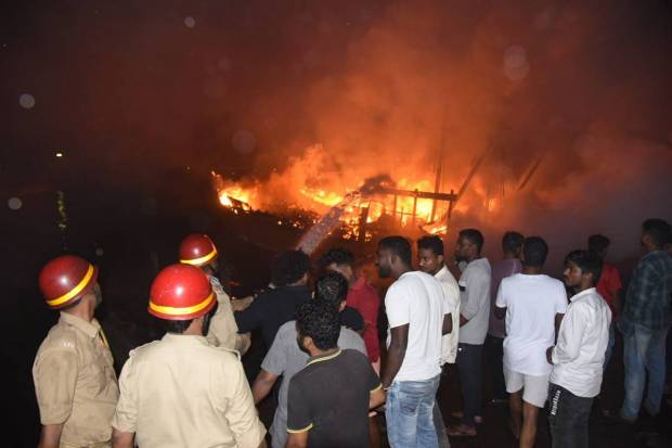 Firefighters attempt to douse a fire that broke out in a jetty area, in Visakhapatnam. (PTI Photo)