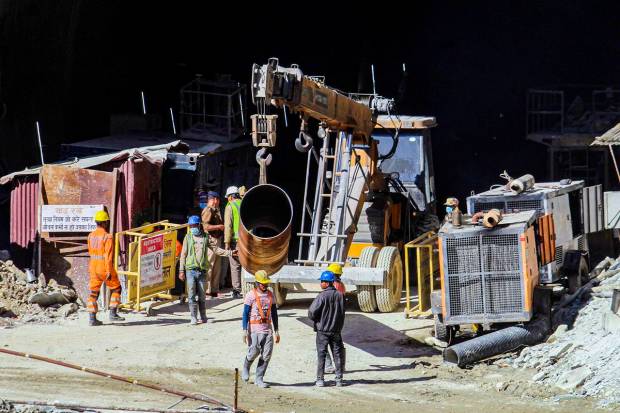 NDRF personnel and others at the under-construction tunnel between Silkyara and Dandalgaon on the Brahmakhal-Yamunotri national highway in Uttarkashi district. (PTI Photo)