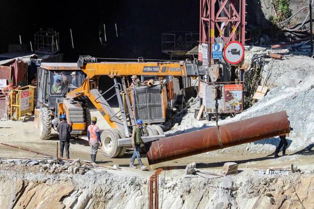 NDRF personnel and others at the under-construction tunnel between Silkyara and Dandalgaon on the Brahmakhal-Yamunotri national highway in Uttarkashi district. (PTI Photo)