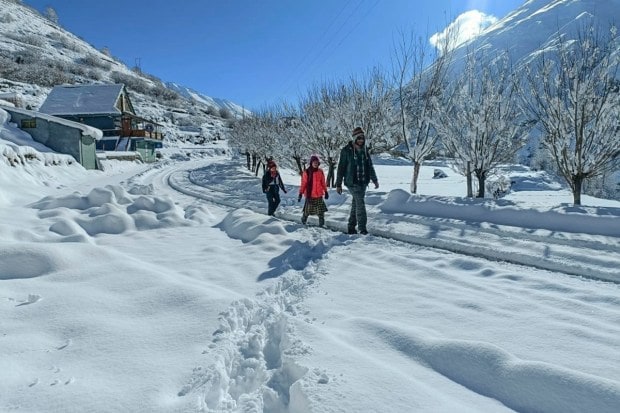 Lahaul & Spiti: Pedestrians on a snow-covered road after snowfall at Shooling village, in Lahaul & Spiti district. (PTI Photo)