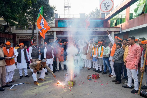 Lucknow: BJP workers and supporters celebrate the party's lead in Madhya Pradesh, Rajasthan and Chhattisgarh during counting of votes for the Assembly elections, in Lucknow. (PTI Photo)