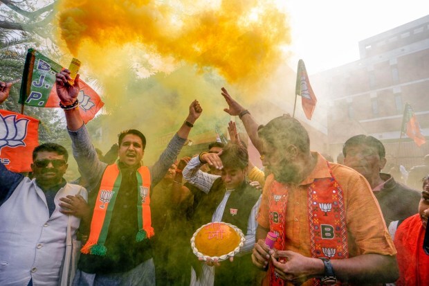 BJP workers and supporters celebrate the party's lead in Madhya Pradesh, Rajasthan and Chhattisgarh during counting of votes, at the party headquarters, in New Delhi, Sunday, Dec. 3, 2023. (PTI Photo)