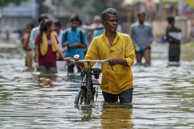 A commuter on a flooded road after heavy rainfall owing to Cyclone Michaung, in Chennai. (PTI Photo)
