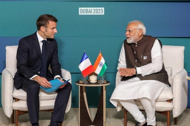 PM modi joins COP28 President and UN Climate Change Executive Secretary at the opening plenary and praises India's balance between development and environment. He said that India is among the few countries on track to achieve its national action plans to limit global warming to 1.5 degrees Celsius. (PTI photo)
