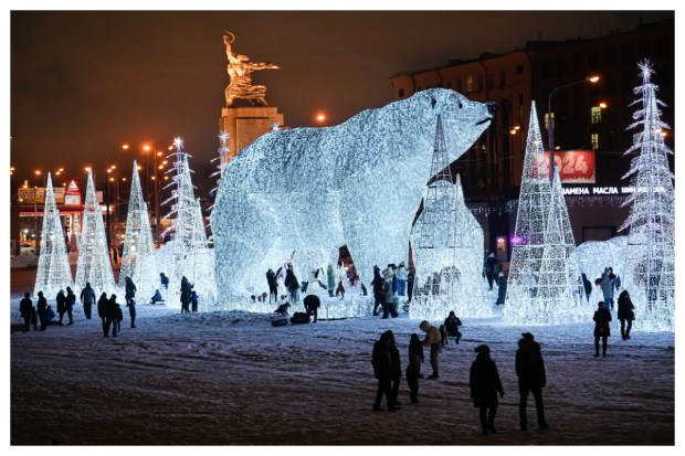 In Moscow, Russia, people stroll and engage in festivities at a park adorned for the New Year and Christmas, featuring the Worker and Kolkhoz (Collective farm) Woman sculpture by renowned Soviet artist Vera Mukhina. (Image: AP Photo)