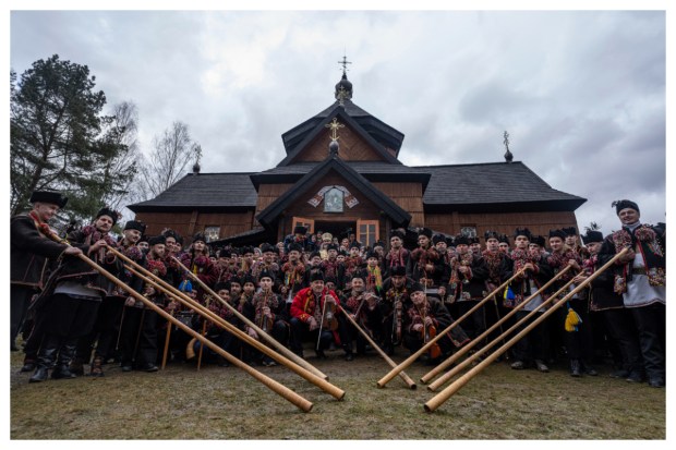 Men don traditional hutsuls suits for a group photo in front of a church, showcasing the festive spirit in Kryvorivnia village, Ukraine, on December 25, 2023. (Image: AP Photo)