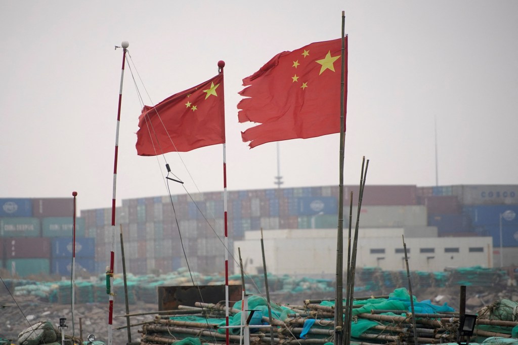 Chinese flags flutter at the Yangshan Deep Water Port in Shanghai, China (Image/Reuters) Chinese flags flutter at the Yangshan Deep Water Port in Shanghai, China (Image/Reuters)