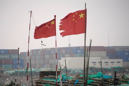 Chinese flags flutter at the Yangshan Deep Water Port in Shanghai, China (Image/Reuters)
