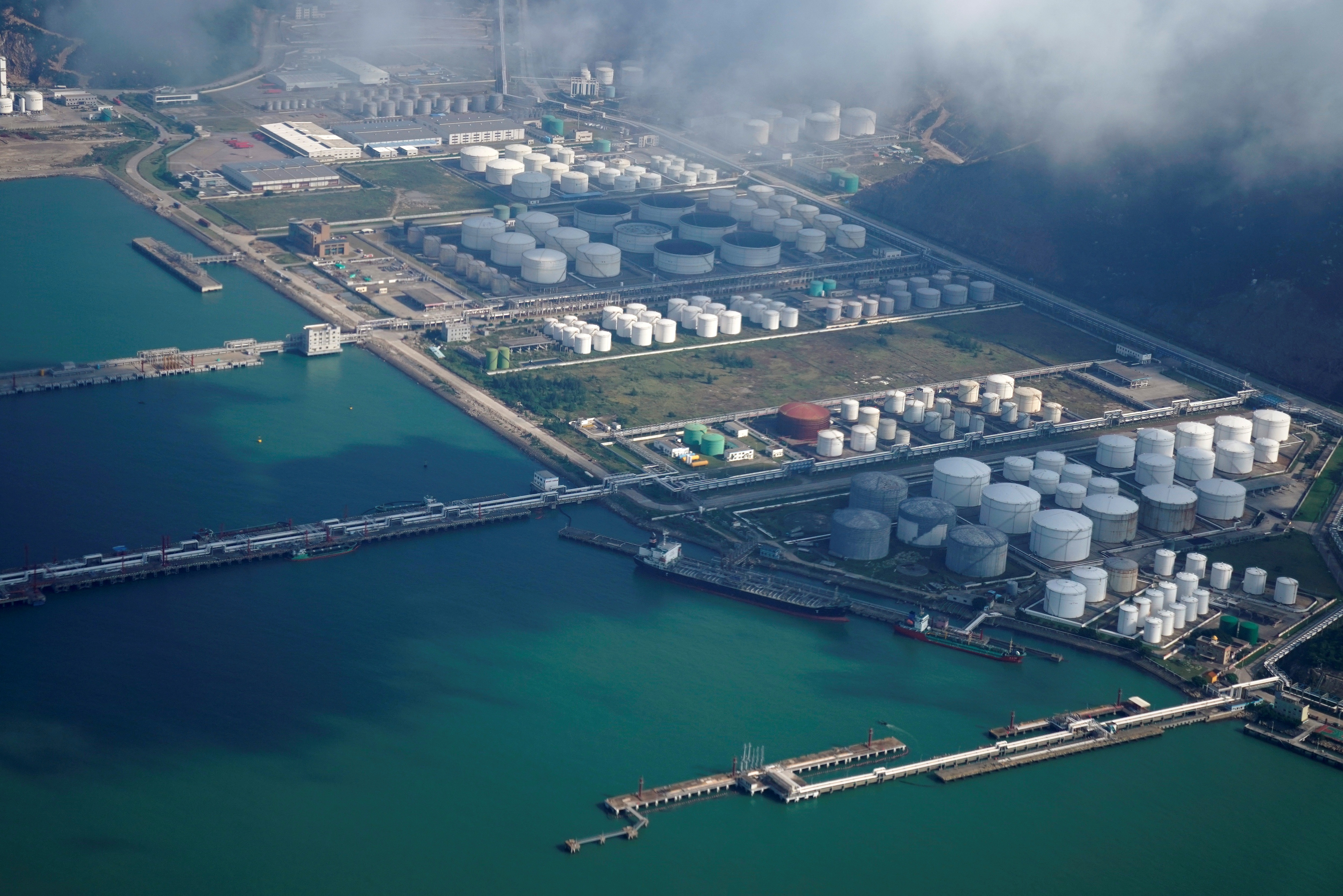 Oil and gas tanks are seen at an oil warehouse at a port in Zhuhai, China (Image/Reuters)