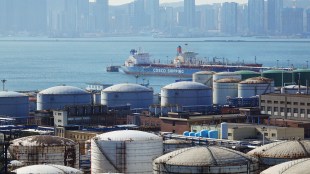 A China Ocean Shipping Company (COSCO) vessel is seen near oil tanks at the China National Petroleum Corporation (CNPC)'s Dalian Petrochemical Corp in Dalian, Liaoning province, China (Image/Reuters)