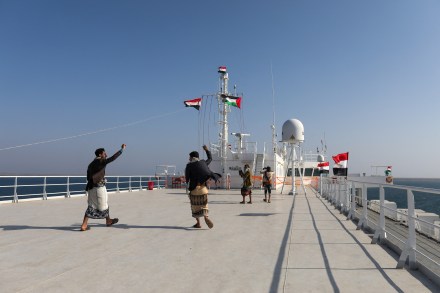 People dance on the deck of the Galaxy Leader commercial ship, seized by Yemen's Houthis last month, off the coast of al-Salif, Yemen (Image/Reuters)