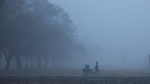 A man walks across the lawns near India Gate on a cold winter morning in New Delhi, India (Image/Reuters)
