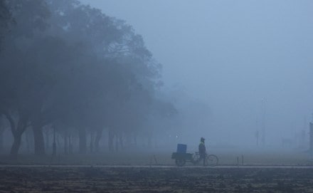 A man walks across the lawns near India Gate on a cold winter morning in New Delhi, India (Image/Reuters)