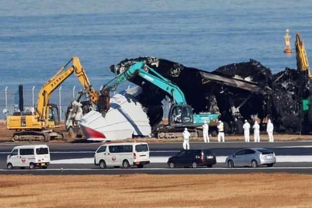 Officials try to remove the wreckage of a burnt Japan Airlines (JAL) Airbus A350 plane after a collision with a Japan Coast Guard aircraft at Haneda International Airport in Tokyo, Japan, January 5, 2024. (Photo: Reuters)