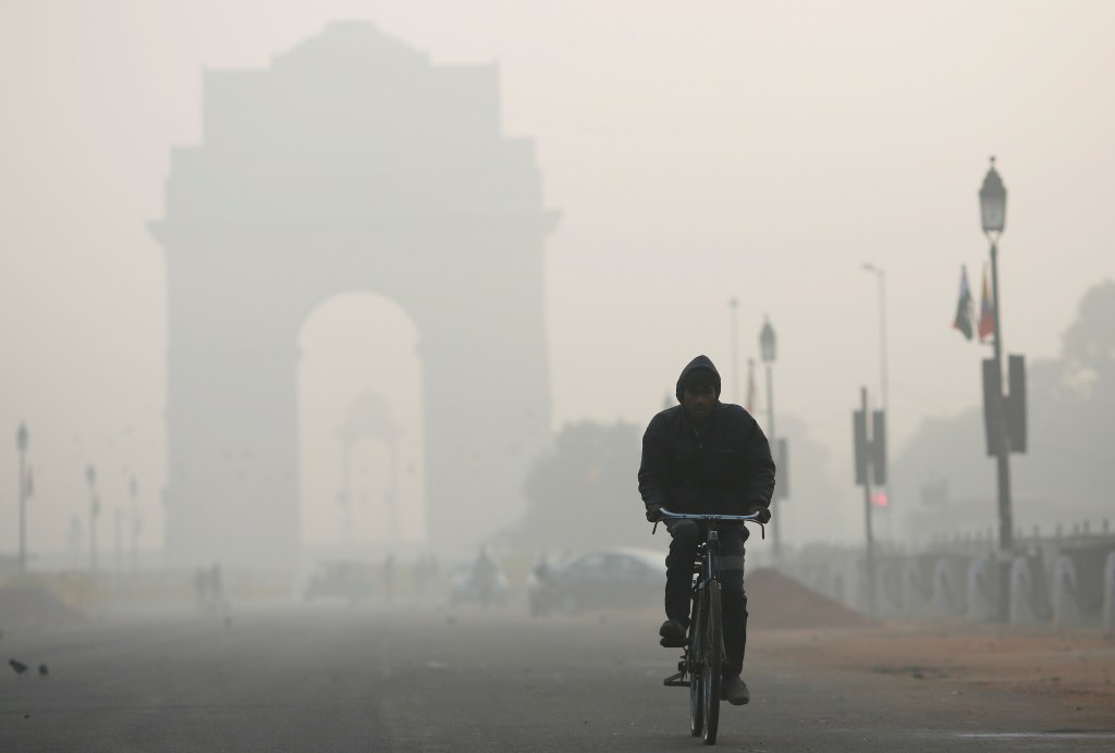 A man rides his bicycle in front of the India Gate (Image/Reuters) A man rides his bicycle in front of the India Gate (Image/Reuters)