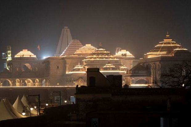 Labourers work on top of the illuminated grand temple of Lord Ram ahead of its opening in Ayodhya. (REUTERS/Adnan Abidi)
