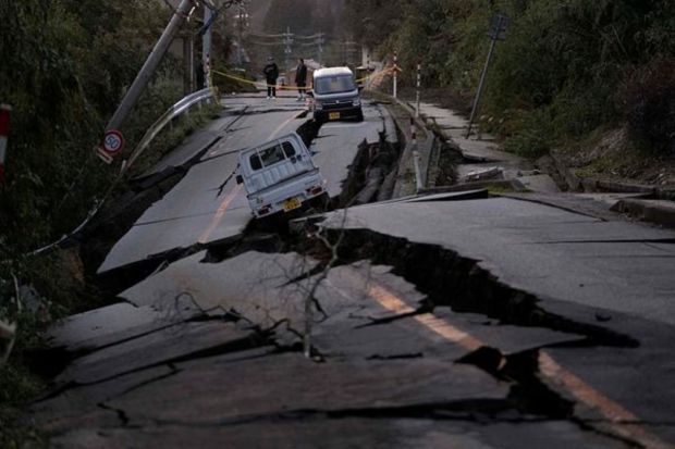 Bystanders look at damages somewhere near Noto town in the Noto peninsula facing the Sea of Japan, northwest of Tokyo, Tuesday, Jan. 2, 2024, following Monday's deadly earthquake. (Photo: AP)