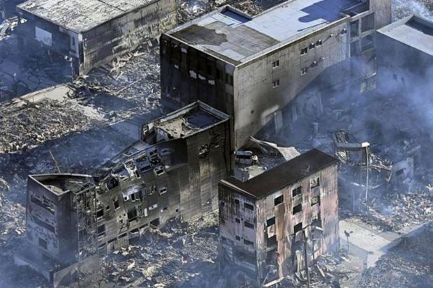 Smoke billows from houses burnt by a fire, following strong earthquake in Wajima, Ishikawa prefecture, Japan Tuesday, Jan. 2, 2024. (Photo: AP)