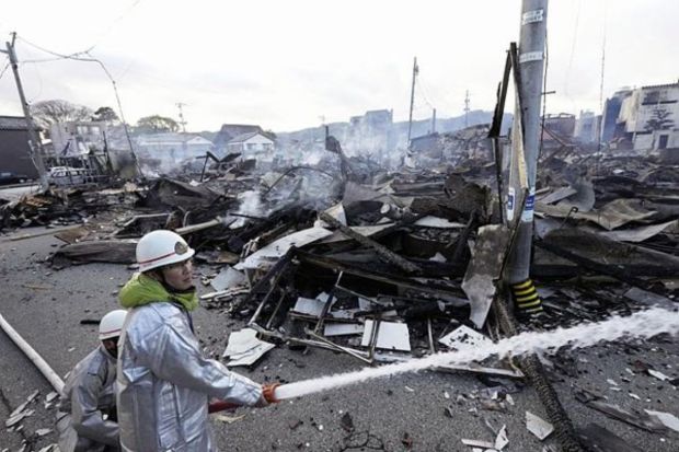 Firefighters work on a fire at burn-out marketplace following earthquake in Wajima, Ishikawa prefecture, Japan Tuesday, Jan. 2, 2024. (Photo: AP)