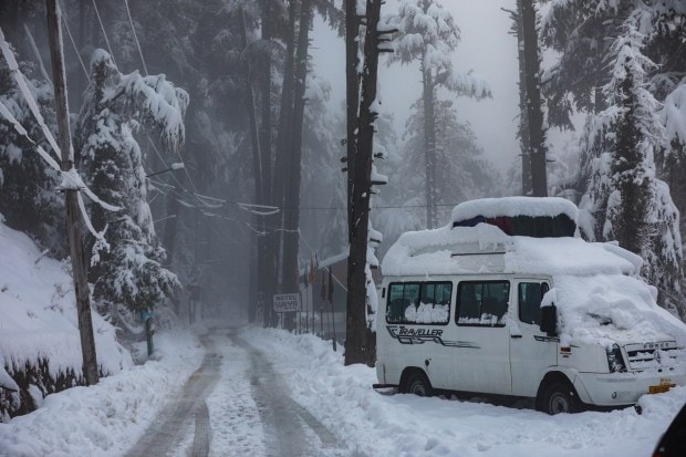 A view of the snow-covered road after heavy snowfall at Patnitop hill station in Jammu (PTI Photo)