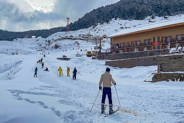 Tourists ski on snow after fresh snowfall at Auli in the Chamoli district of Uttarakhand (PTI Photo)