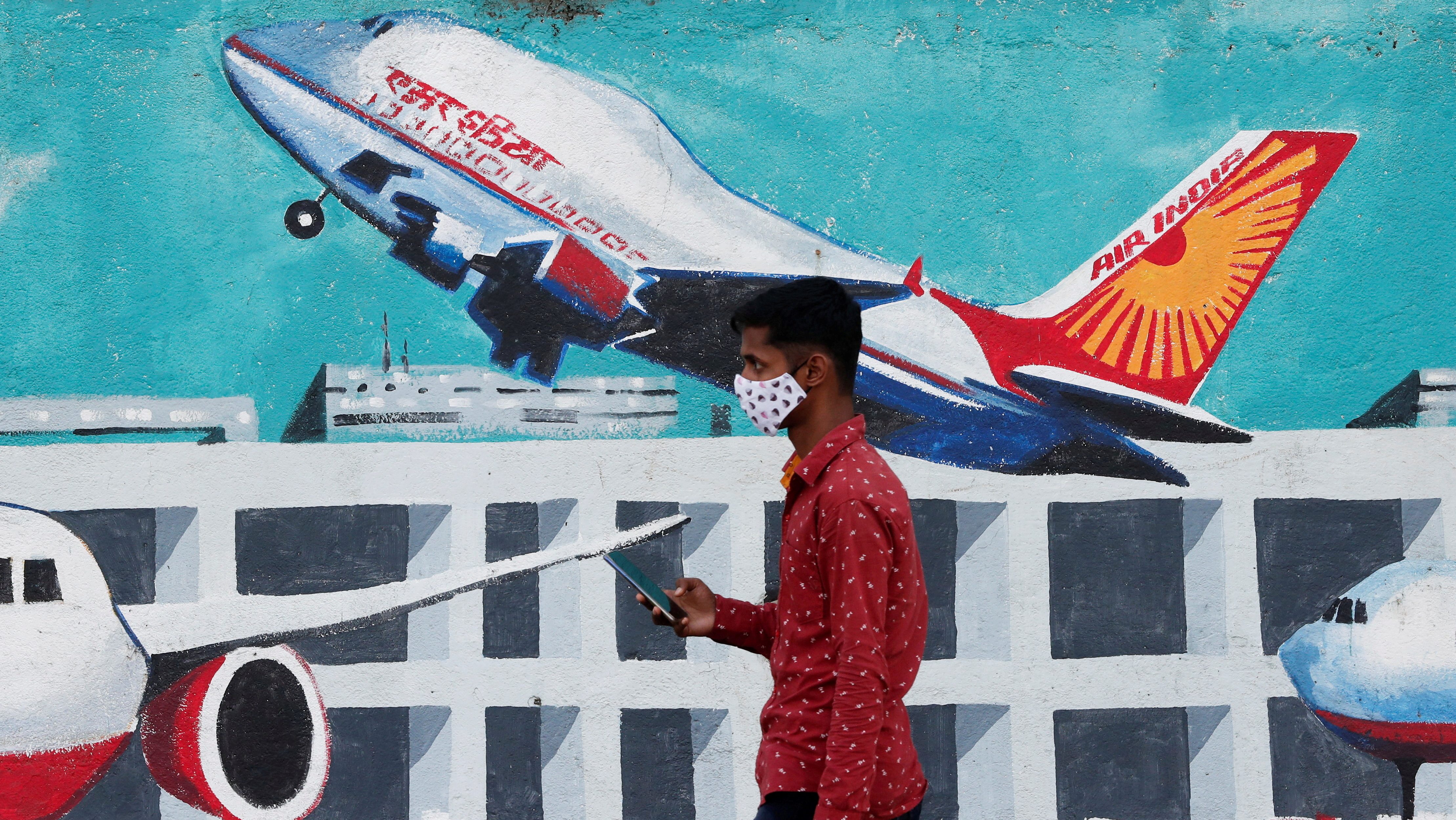 A man walks past a mural of Air India airlines on a street in Mumbai (Image/Reuters)