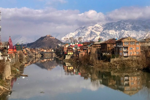 A view of the Jhelum river in the backdrop of under snow-covered Zabarwan mountain range after fresh snowfall in Srinagar (PTI Photo)