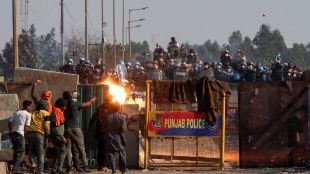 Farmers confront the police as they march towards New Delhi