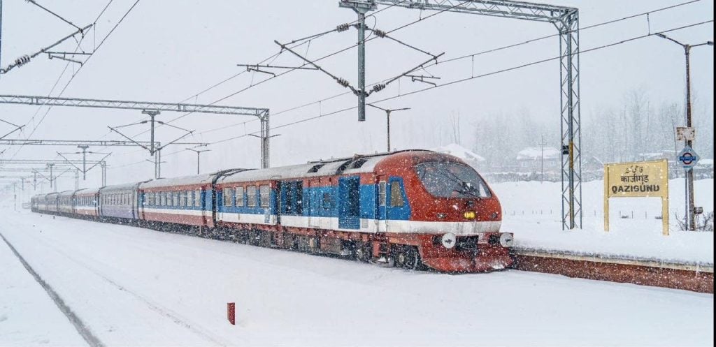 Train glides through snowclad Qazigund station on Udhampur-Srinagar-Baramulla Rail Link (Image/@AshwiniVaishnaw)
