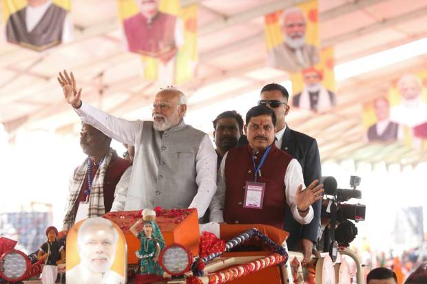 Prime Minister Narendra Modi with Union Tribal Affairs Minister Arjun Munda and Madhya Pradesh Chief Minister Mohan Yadav at a roadshow during 'Janjatiya Sammelan' in Jhabua, Madhya Pradesh. (PTI Photo)