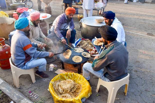 Farmers prepare food for themselves at the Punjab-Haryana Shambhu border during farmers's 'Delhi Chalo' protest, near Patiala district. (PTI Photo)