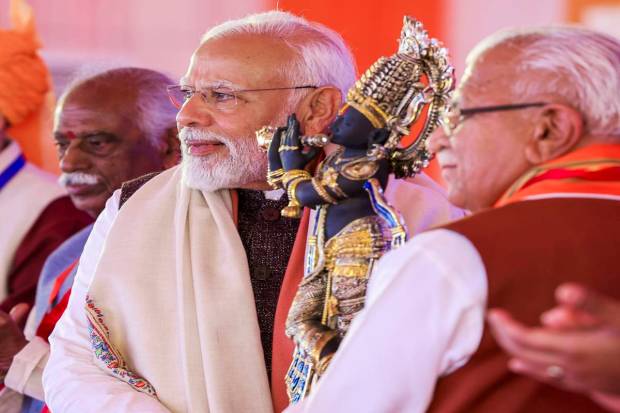Prime Minister Narendra Modi being presented a memento during the foundation stone laying and inauguration of various development projects, in Rewari district. (PTI Photo)