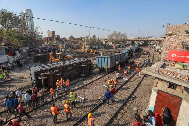 Officials during restoration work after bogies of a goods train derailed near Sarai Rohilla Railway station, in New Delhi. (PTI Photo)