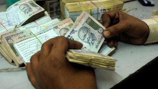 An employee counts currency notes at a cash counter inside a bank in Agartala, India (Image/Reuters)