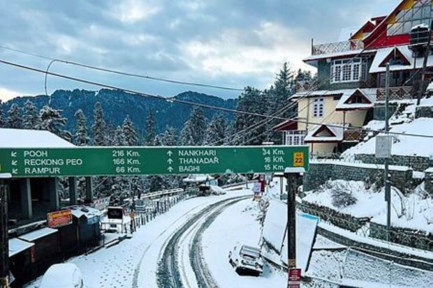 Roads and vehicles covered in snow after fresh snowfall at Narkanda, in Shimla district. (PTI Photo)