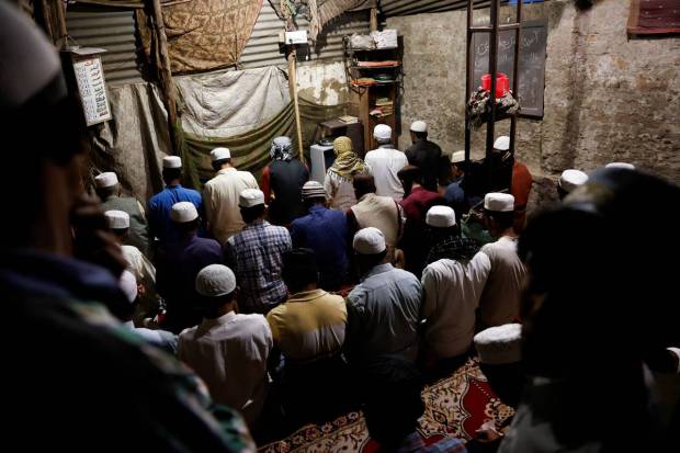 Rohingya refugees pray at a makeshift masjid at a camp after the Iftar (breaking of fast) meal during the Muslim fasting month of Ramadan in New Delhi, India. REUTERS
