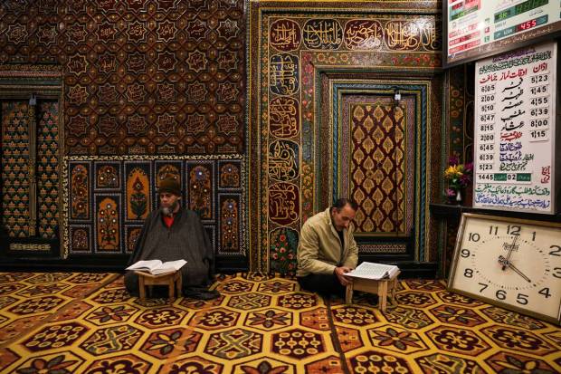Kashmiri Muslim men read the Koran inside the shrine of Sufi Saint Mir Syed Ali Hamadani on the second day of the Muslim holy fasting month of Ramadan in Srinagar. REUTERS