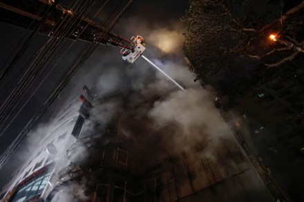 Firefighters spray water to douse a fire that broke out in a multi-storey building in Dhaka (Image/Reuters)