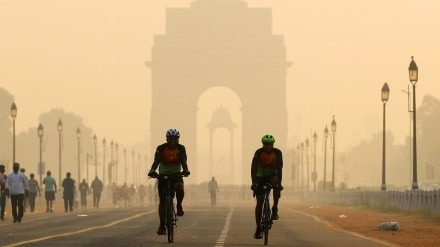 Men ride their bicycles in front of the India Gate in New Delhi (Image/Reuters) Men ride their bicycles in front of the India Gate in New Delhi (Image/Reuters)