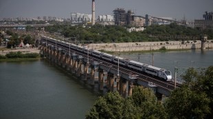 India's high-speed train 'Vande Bharat Express' passes a railway bridge after being inaugurated by Prime Minister Narendra Modi, in Ahmedabad