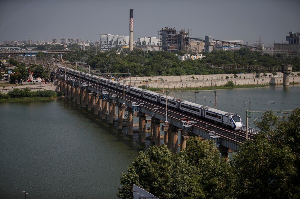 India's high-speed train 'Vande Bharat Express' passes a railway bridge after being inaugurated by Prime Minister Narendra Modi, in Ahmedabad India's high-speed train 'Vande Bharat Express' passes a railway bridge after being inaugurated by Prime Minister Narendra Modi, in Ahmedabad