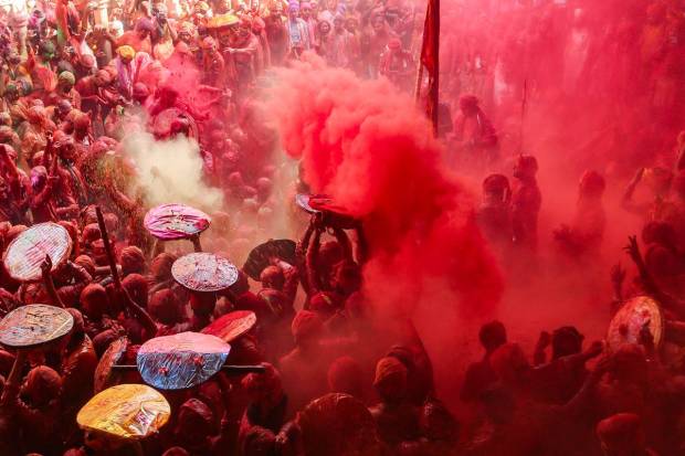 Devotees during Latthamaar Holi celebration at Sri Ji temple near Mathura. (PTI Photo)