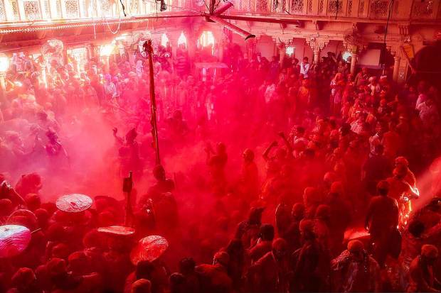 Devotees during Latthamaar Holi celebration at Sri Ji temple near Mathura. (PTI Photo)