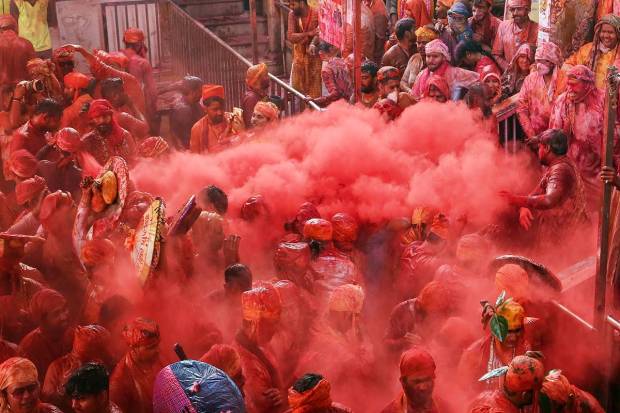 Devotees during Latthamaar Holi celebration at Sri Ji temple at Barsana near Mathura. (PTI Photo)