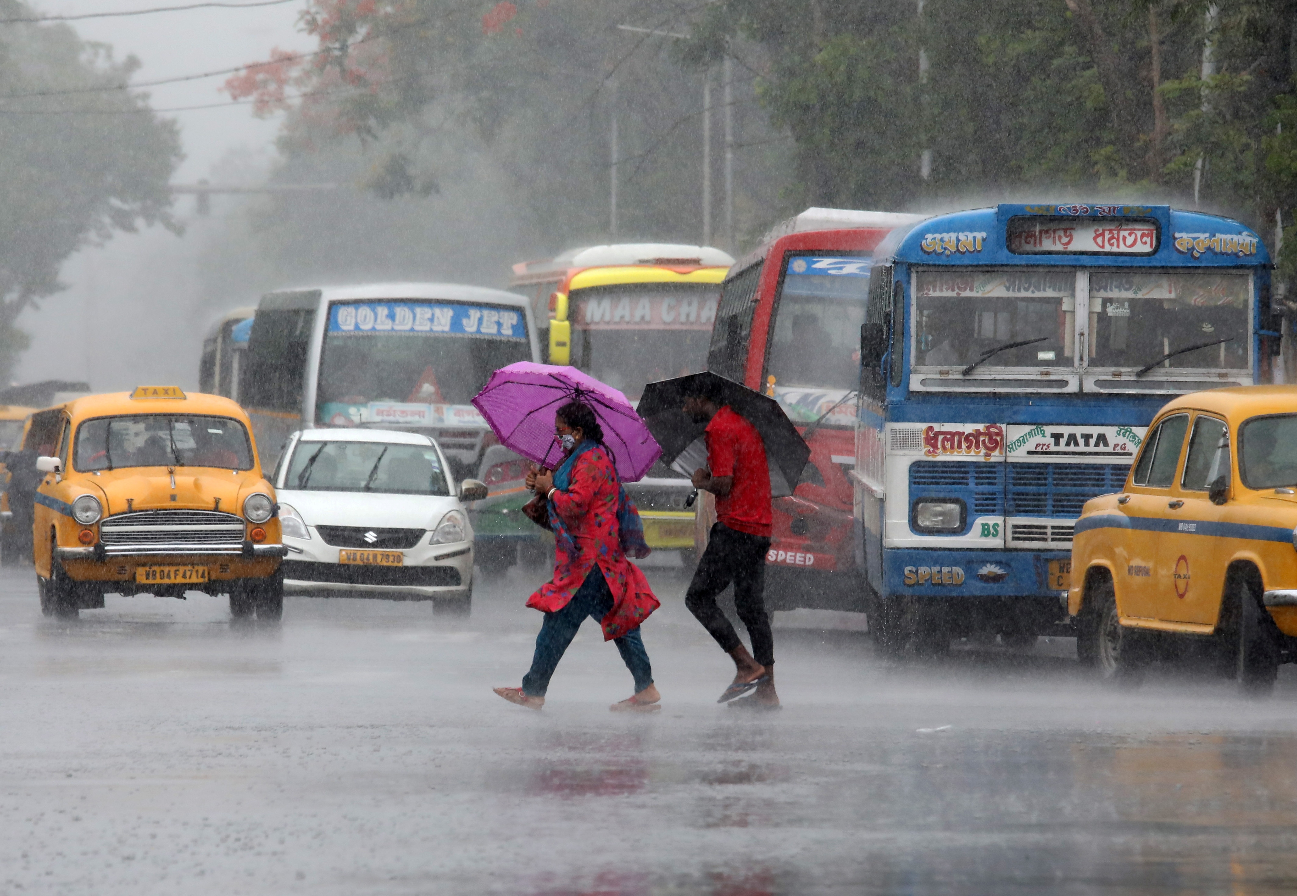 Commuters with umbrellas cross a road during heavy rains in Kolkata (File Image/Reuters)