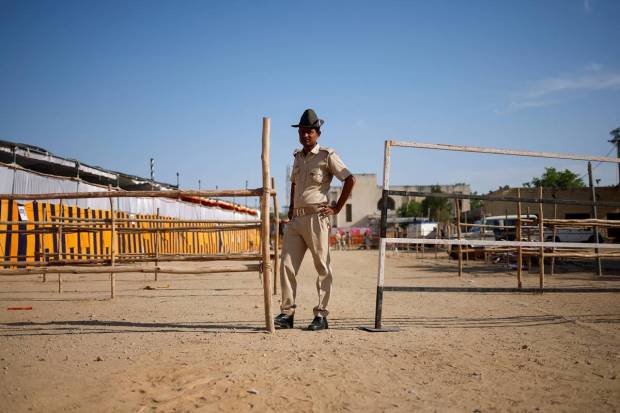 A security officer stands guard at an election material distribution centre, ahead of the second phase of the general elections, in Barmer in the desert state of Rajasthan. REUTERS