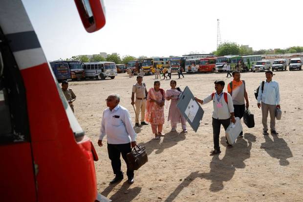 Election officials look for their designated vehicle after collecting election materials from a distribution centre, ahead of the second phase of the general elections, in Barmer in the desert state of Rajasthan. REUTERS