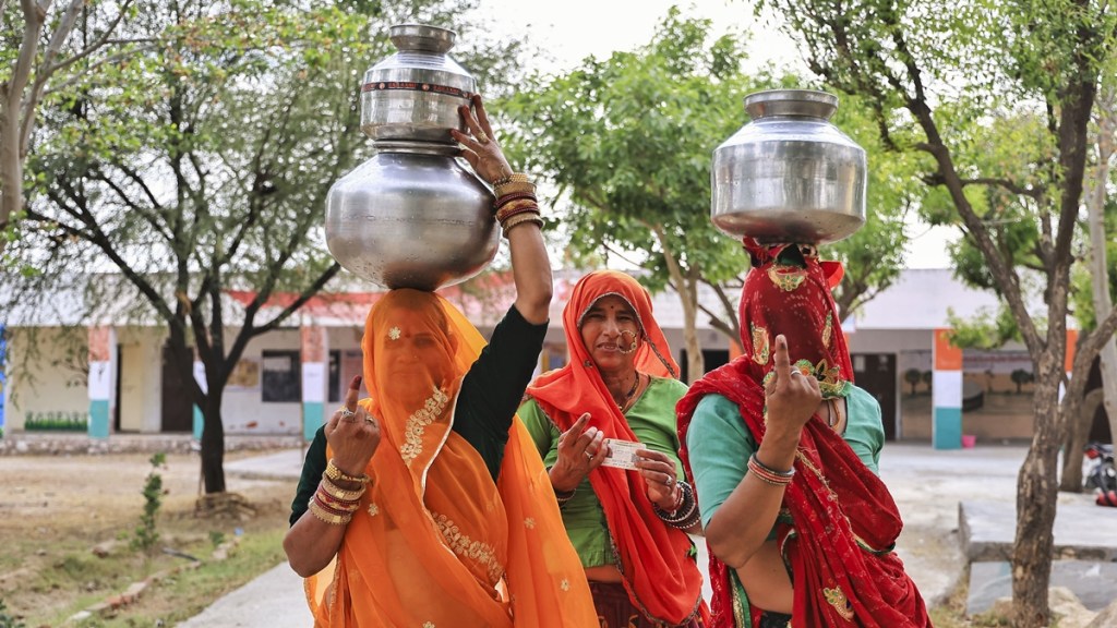 Women voters show their fingers marked with indelible ink after casting votes during the second phase of Lok Sabha elections, in Dudu district, Friday, April 26, 2024. (PTI Photo)